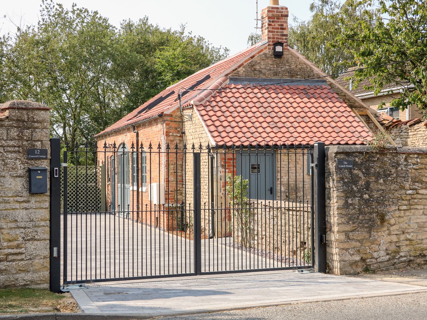The Coach House exterior behind its gates in Cranwell Village